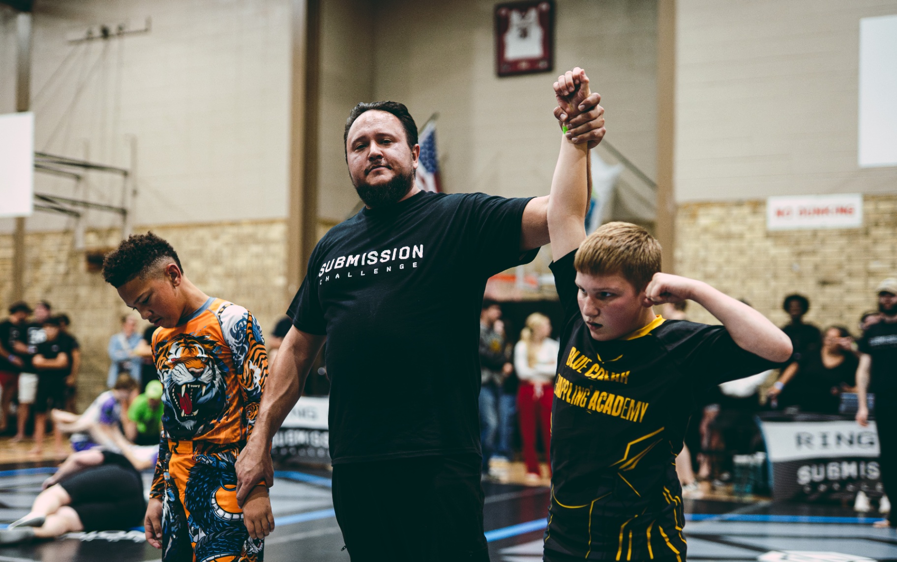 Referee raising young competitor's hand